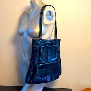 Black soft leather bag with outer pockets and pink lining